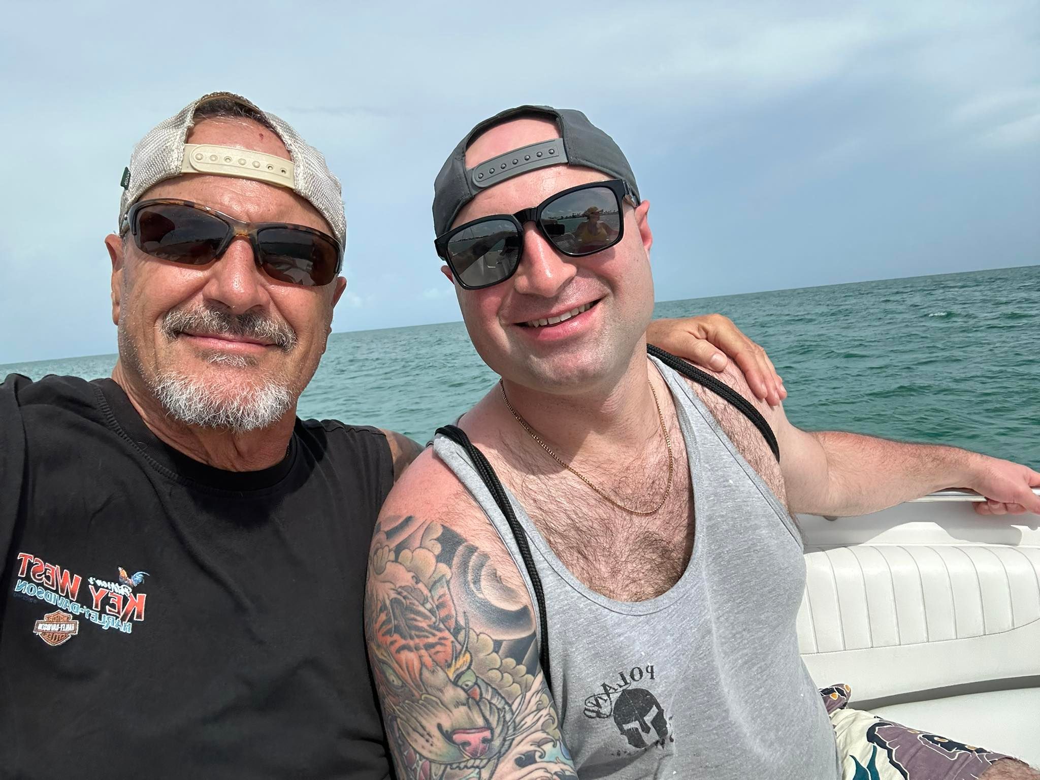 Two people enjoying a day out on a boat in open water