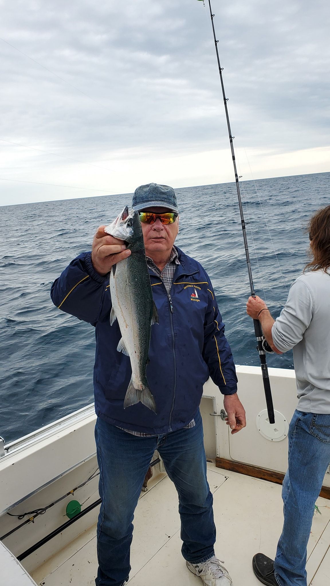 Angler catches a rainbow trout in an unknown location