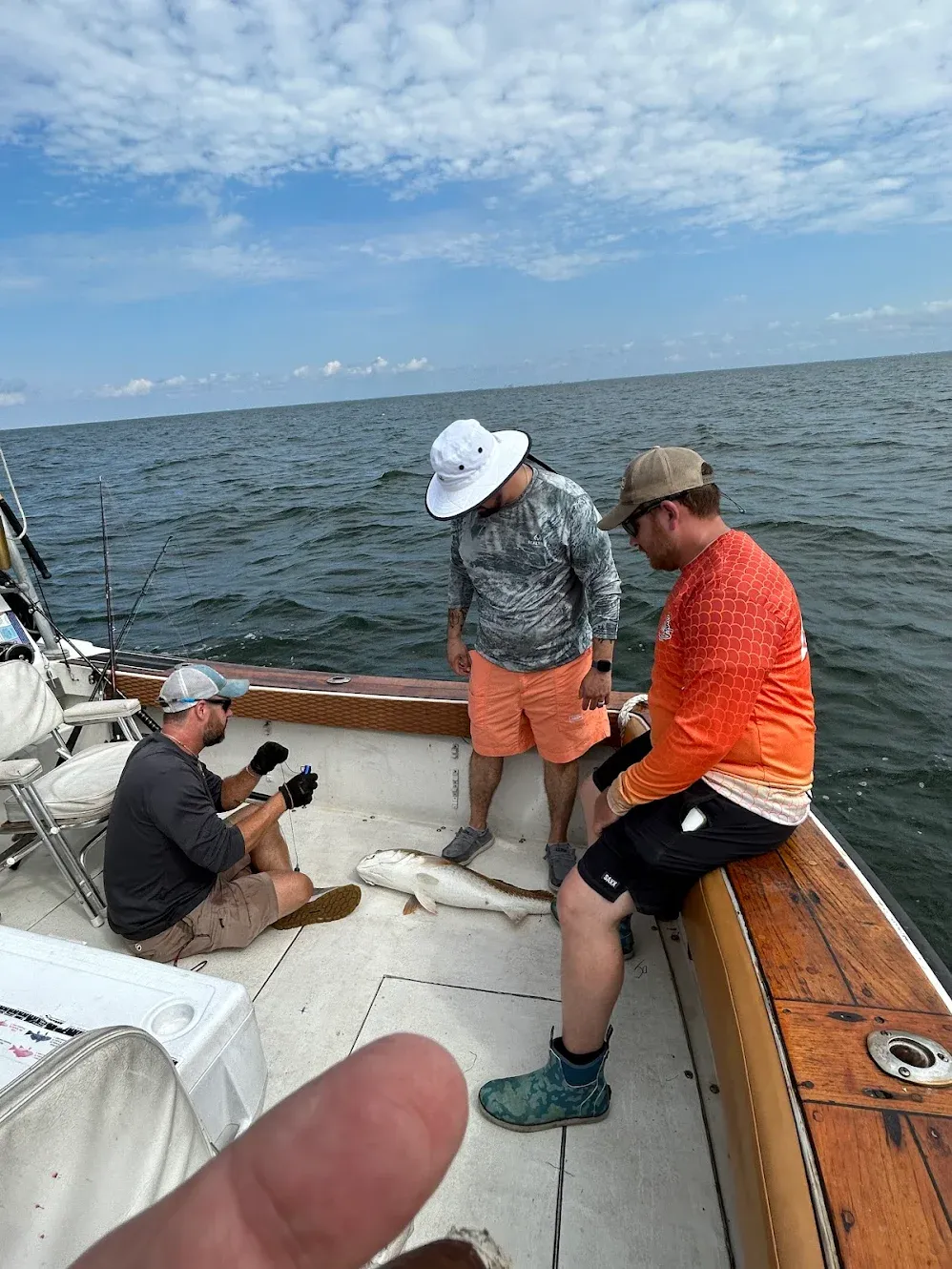 Two people fishing in an unknown location