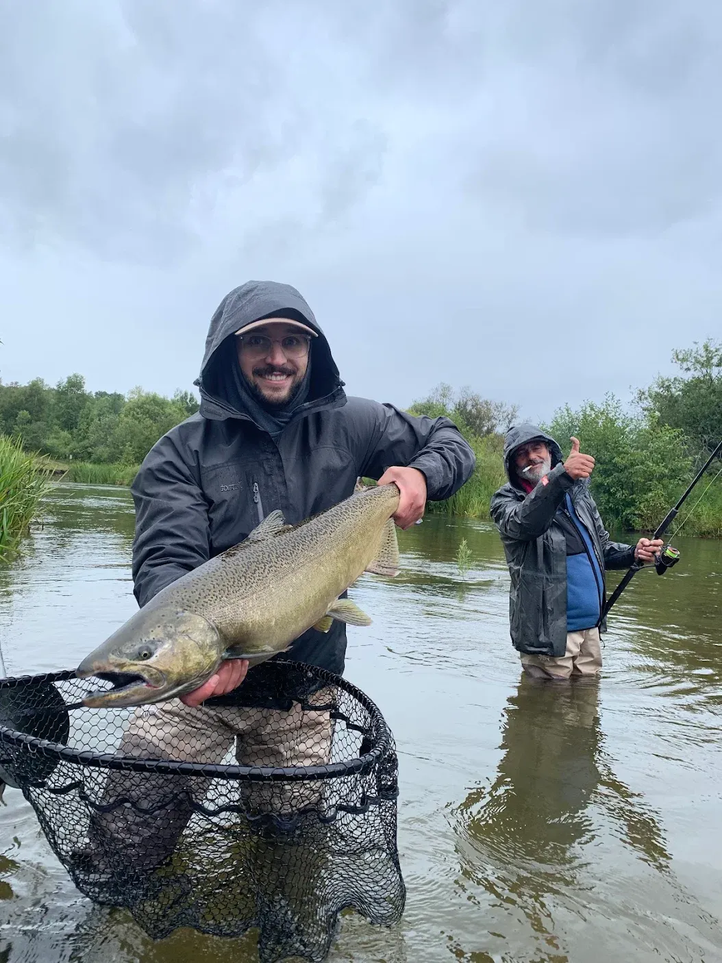 Two people fishing in an unknown location