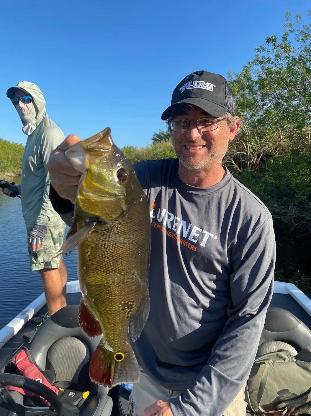 A person fishing in an unknown location