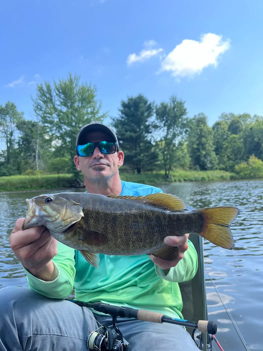 A person fishing at an unknown location