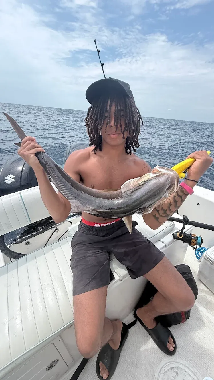 Large eel caught during fishing trip displayed on boat deck