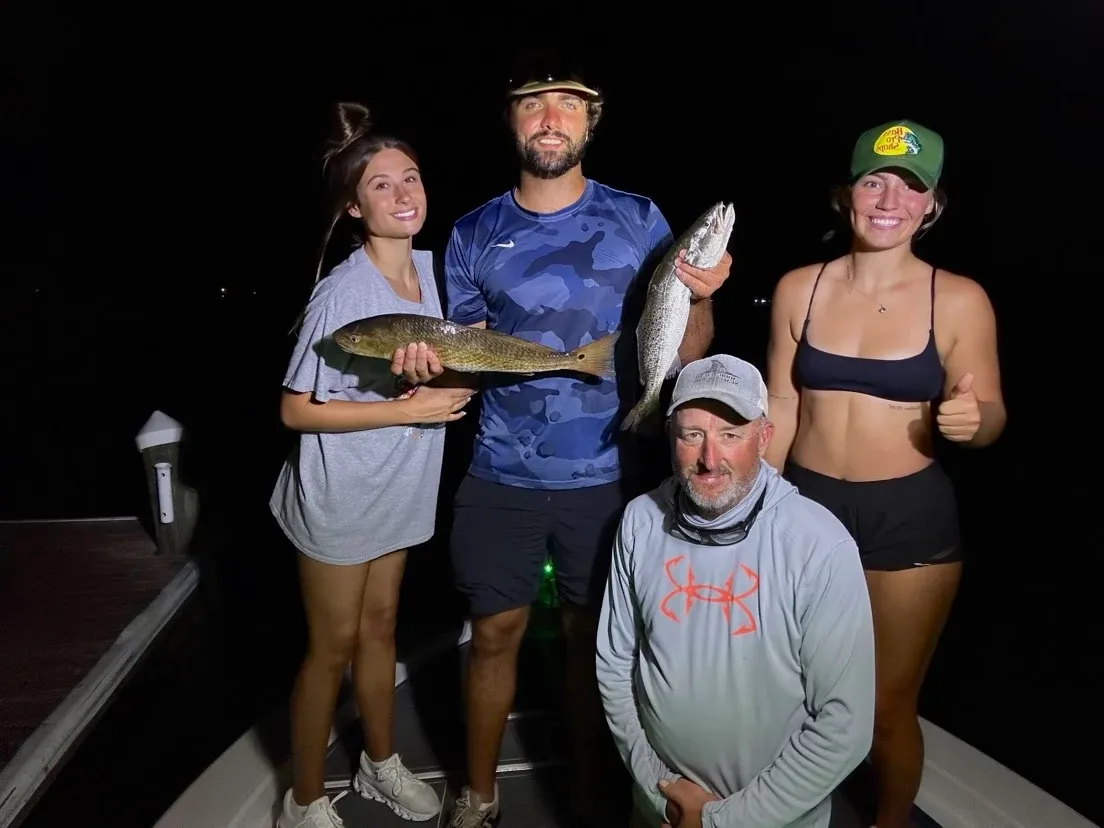 Successful night fishing trip displaying caught redfish and speckled trout
