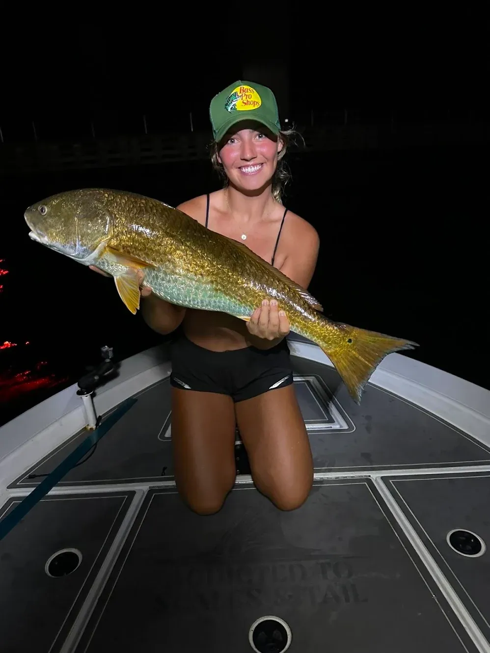 Large redfish caught during night fishing trip on boat deck