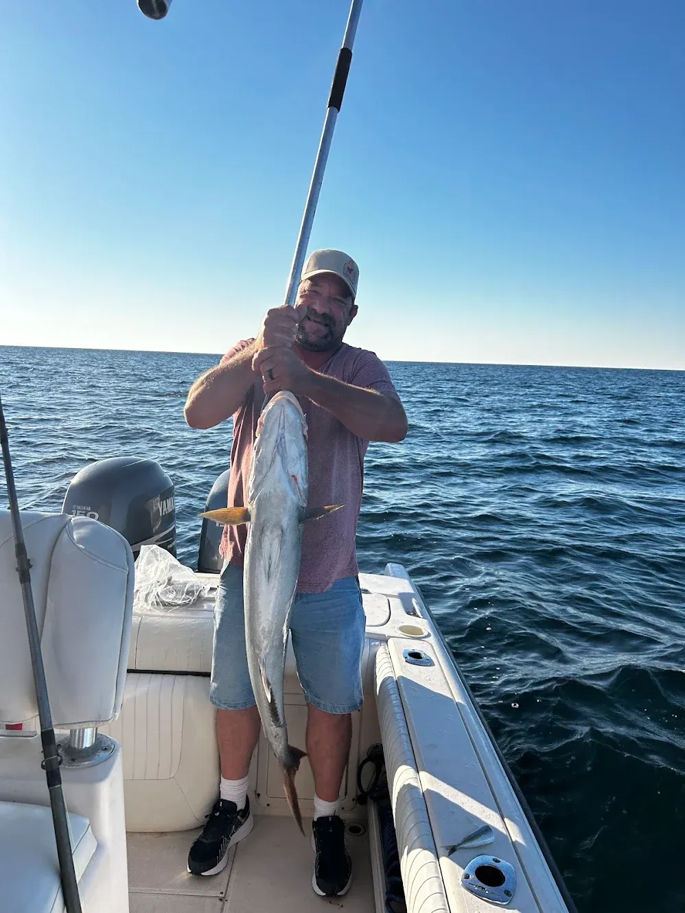 Large silver fish caught during offshore fishing trip on boat