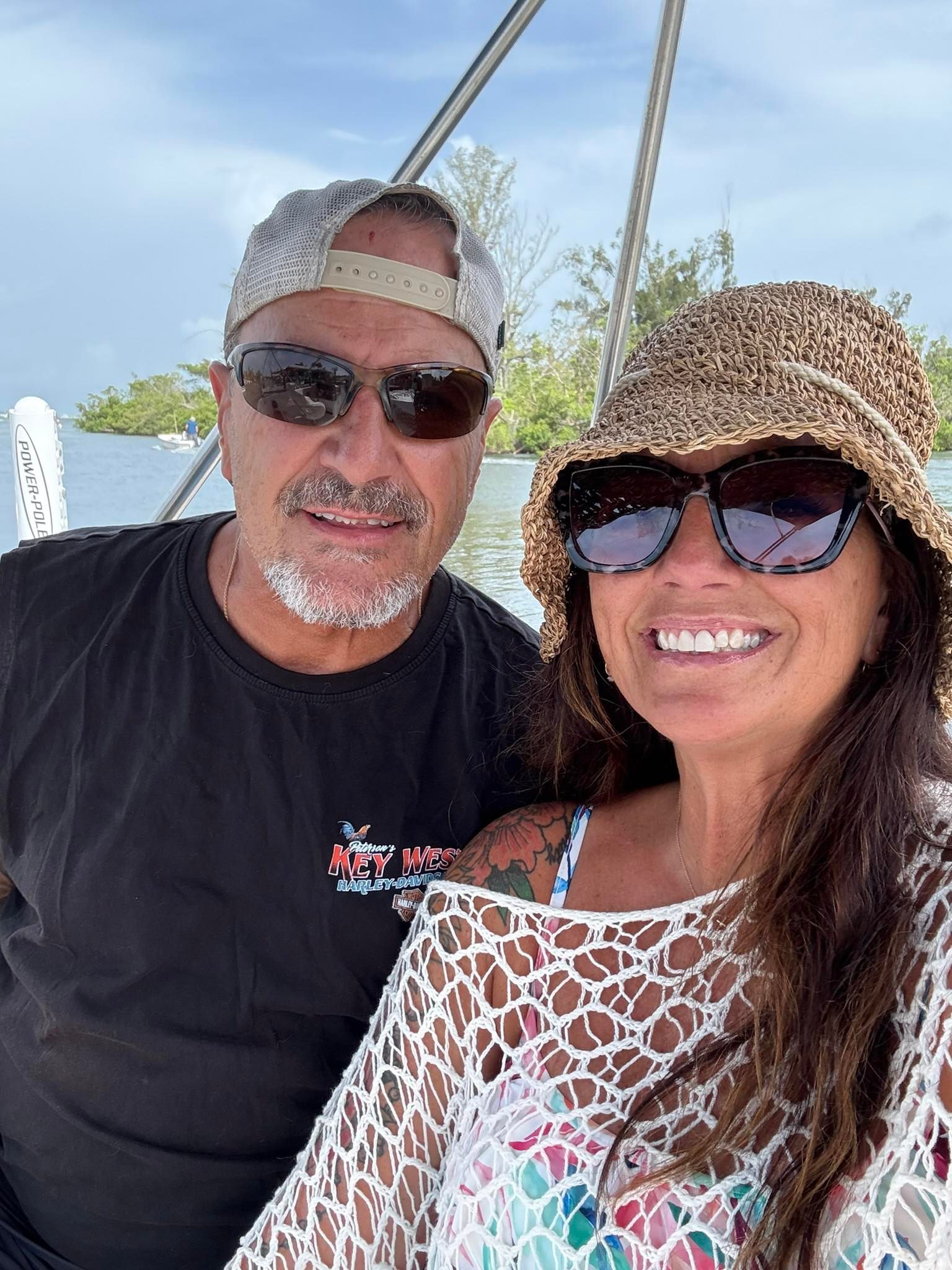 Outdoor boating scene on calm water with trees visible in background