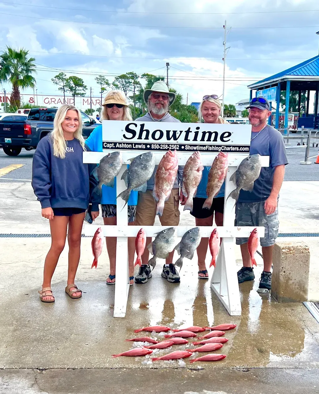 Successful fishing trip displaying multiple red grouper and other fish species on cleaning station