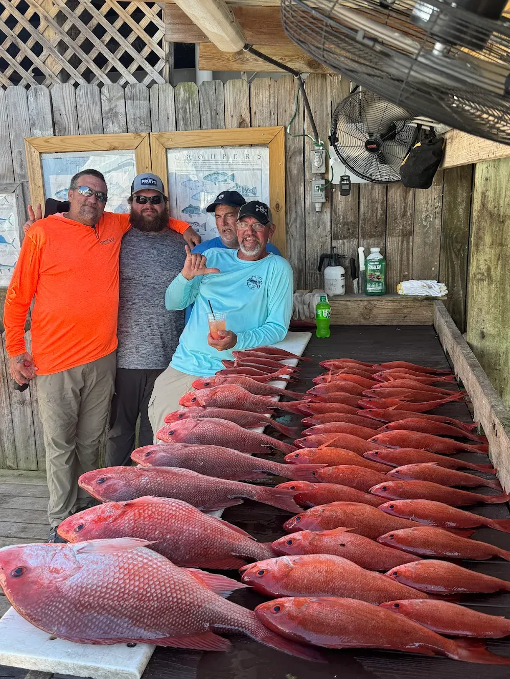 Large catch of red snapper fish displayed on cleaning table at fish cleaning station