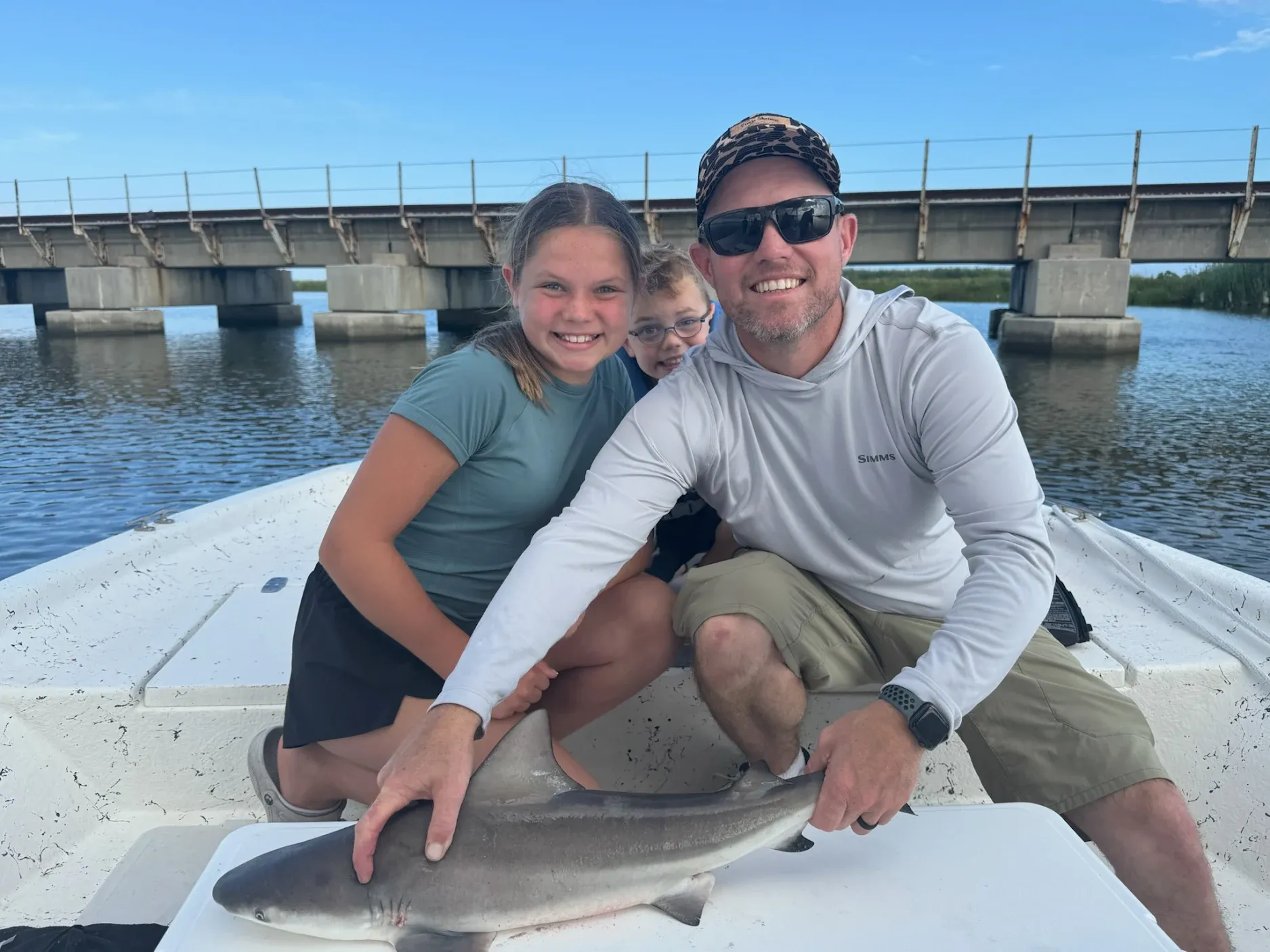 Three people fishing on a scenic location
