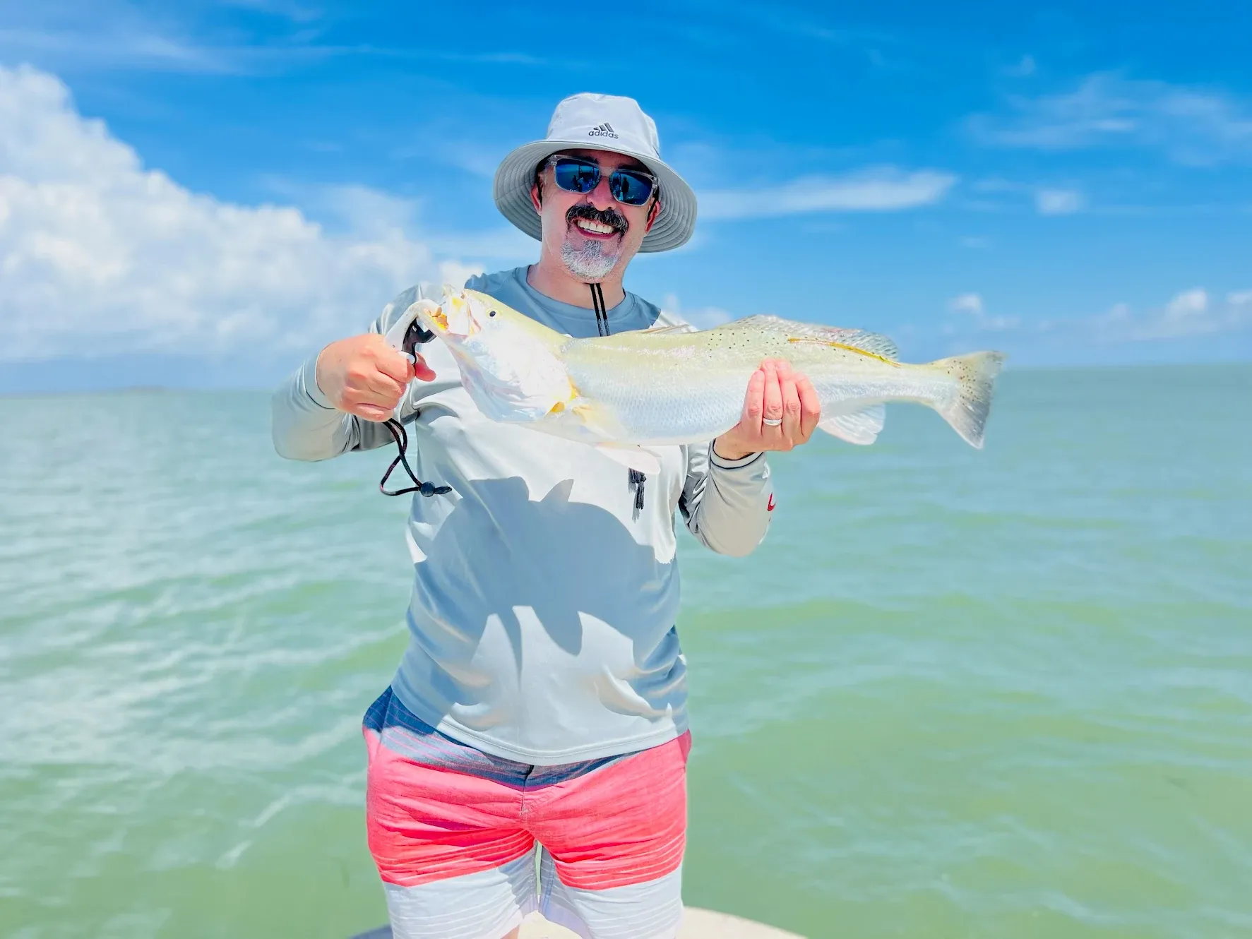 Angler with a 21-inch fish during an unknown fishing trip