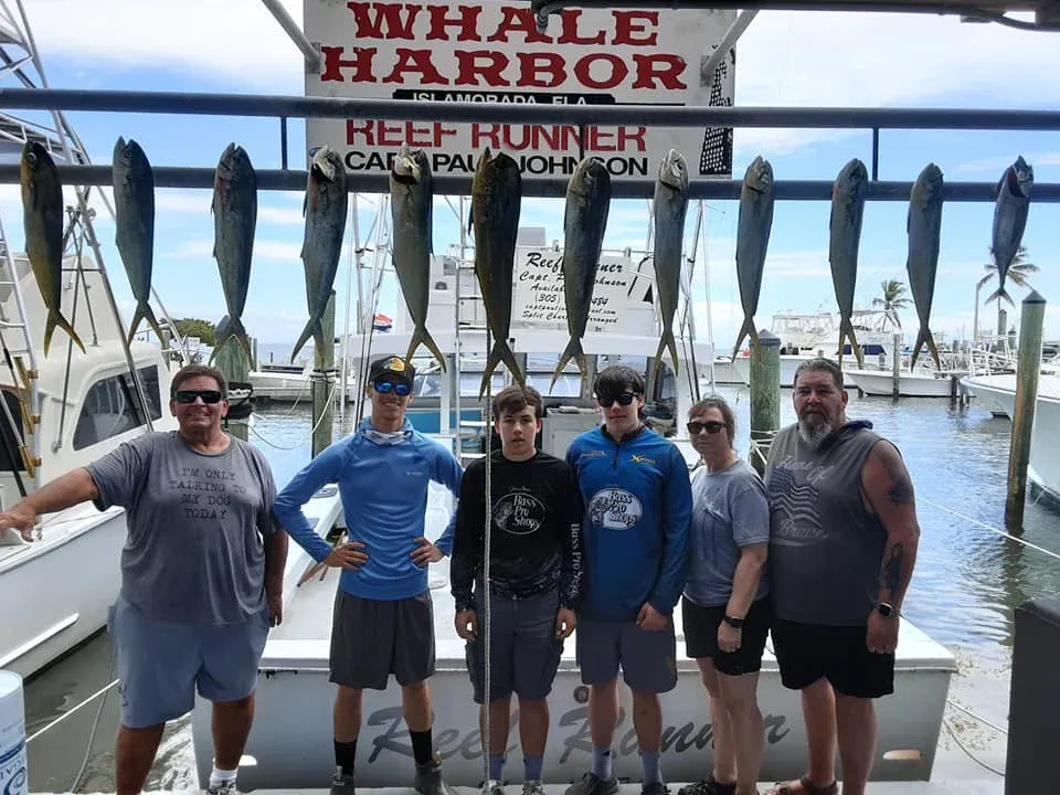 Anglers with 11 freshly caught fish in unknown location