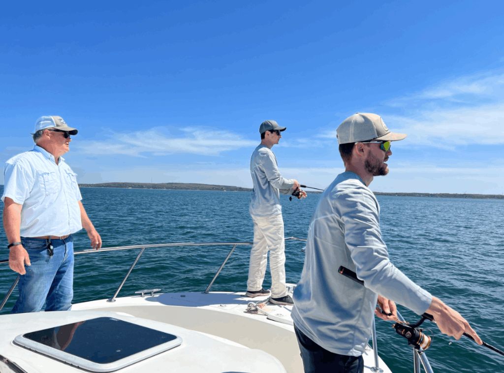 Three people fishing in a scenic location
