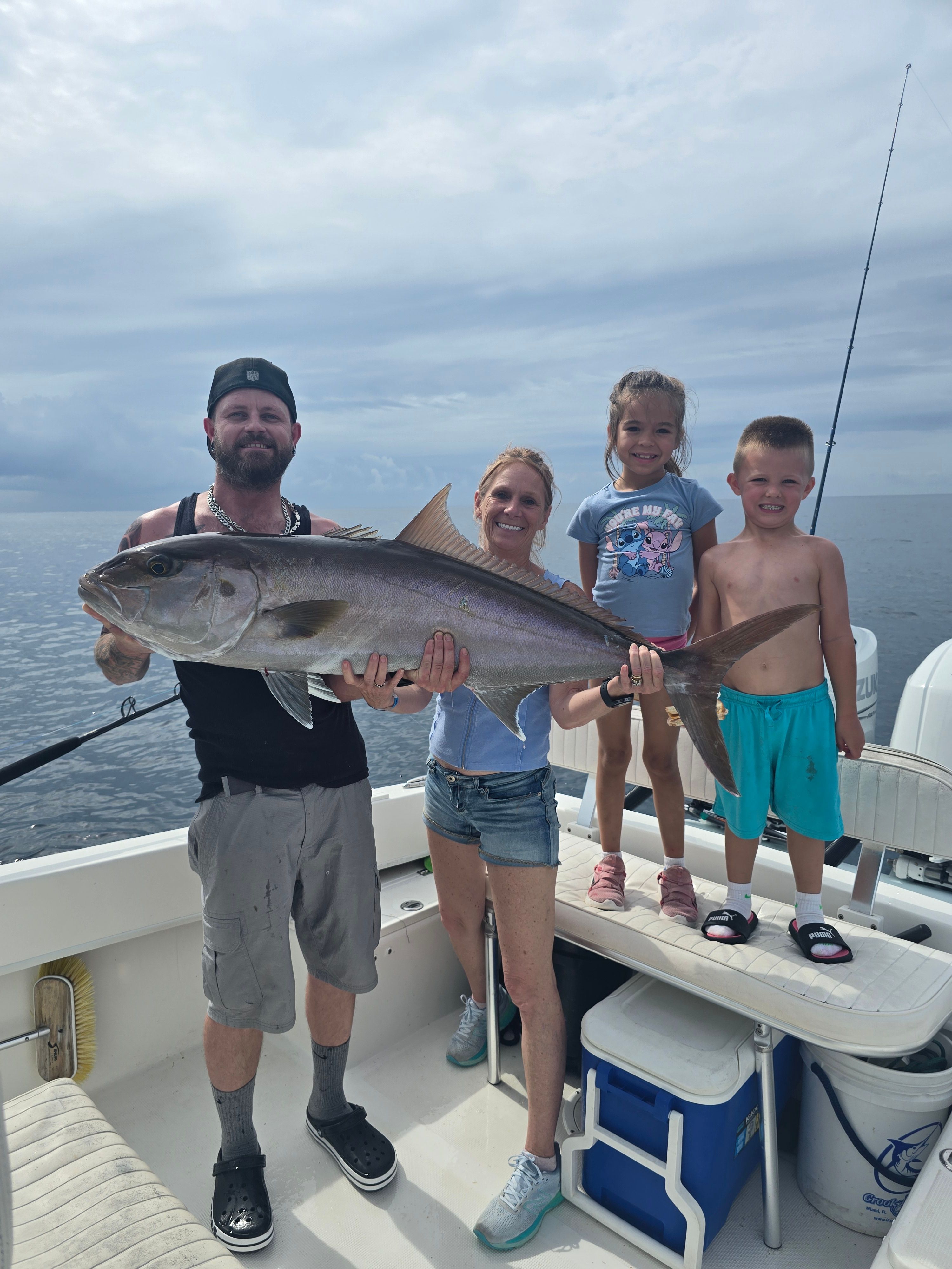 Greater amberjack caught during offshore fishing trip on boat deck