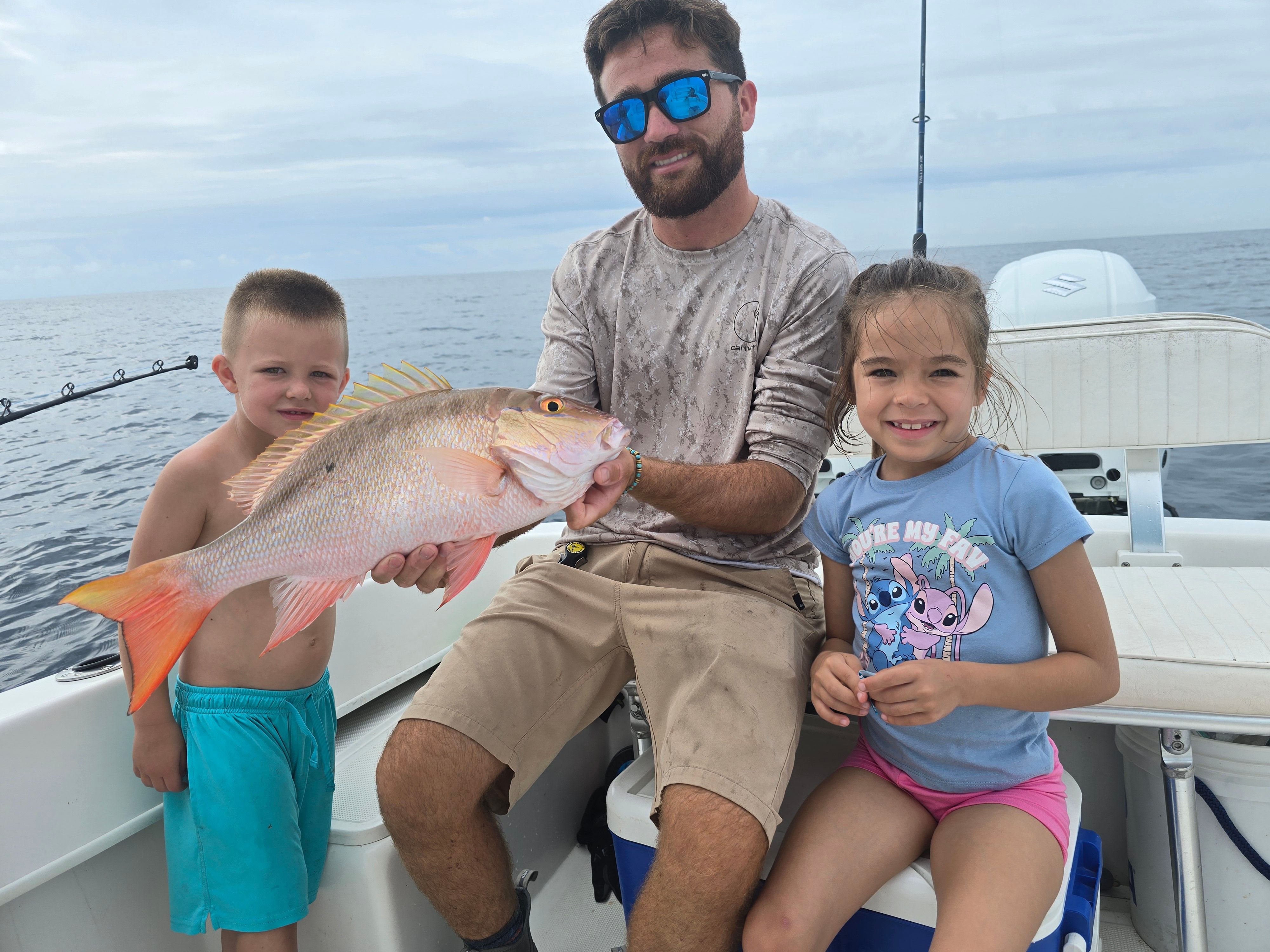 Mutton snapper caught during fishing trip on boat in ocean waters