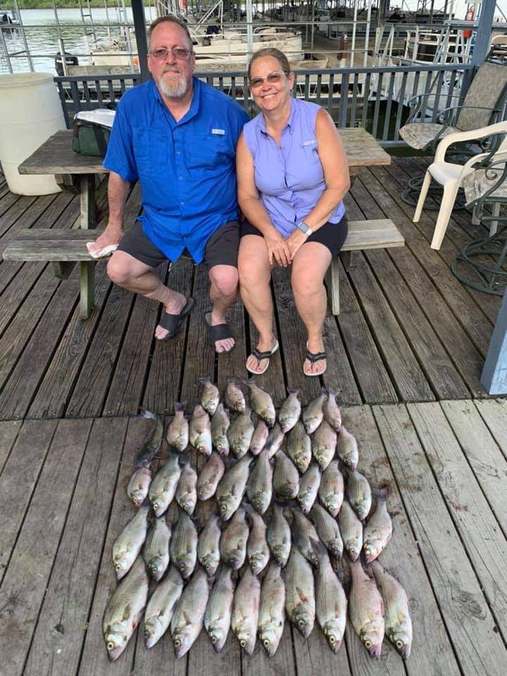 Two people fishing in a scenic location