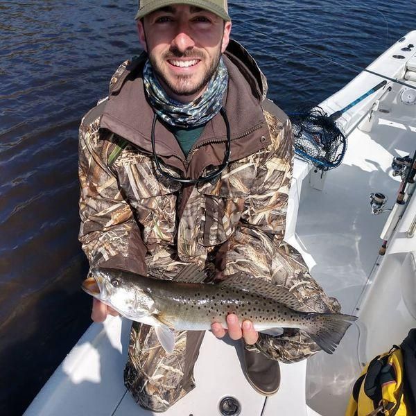 A photo of a spotted weakfish measuring 14 inches, caught while fishing.