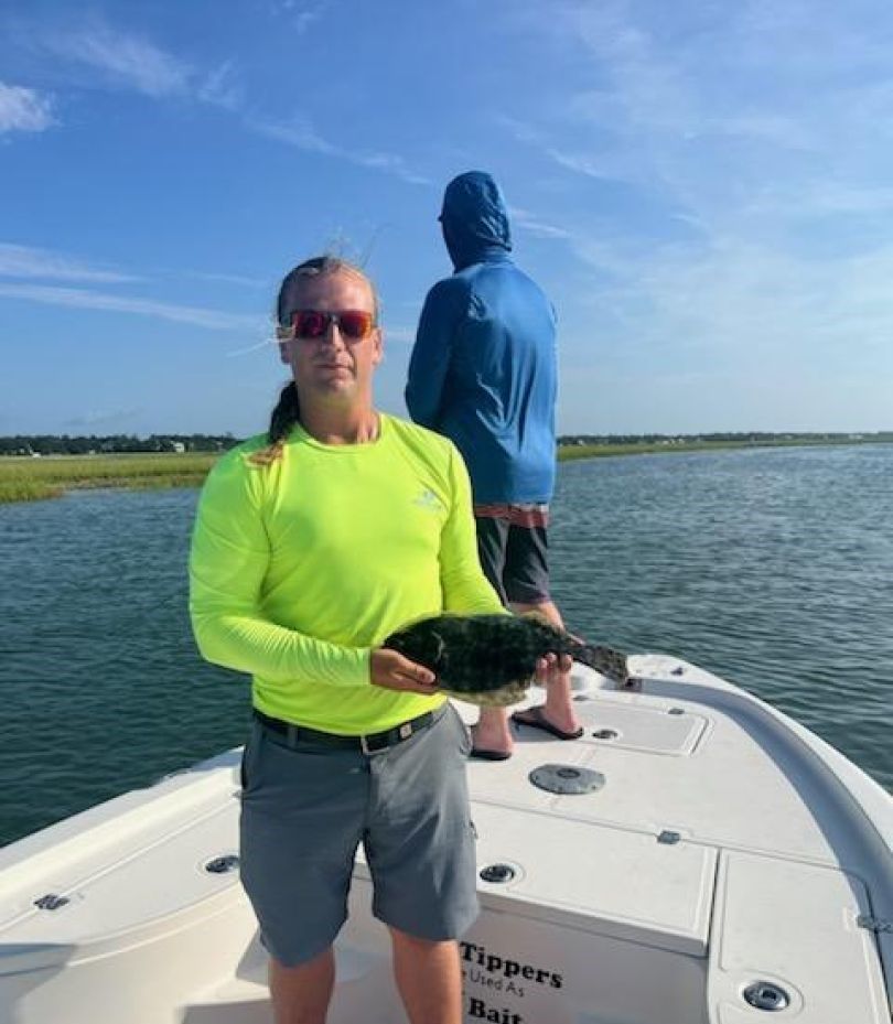 Angler with a 12-inch fish caught while fishing