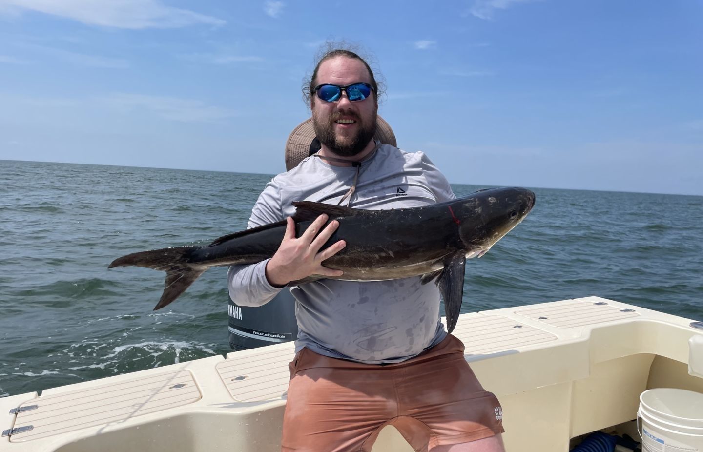 Angler with a 16-inch fish in unknown location