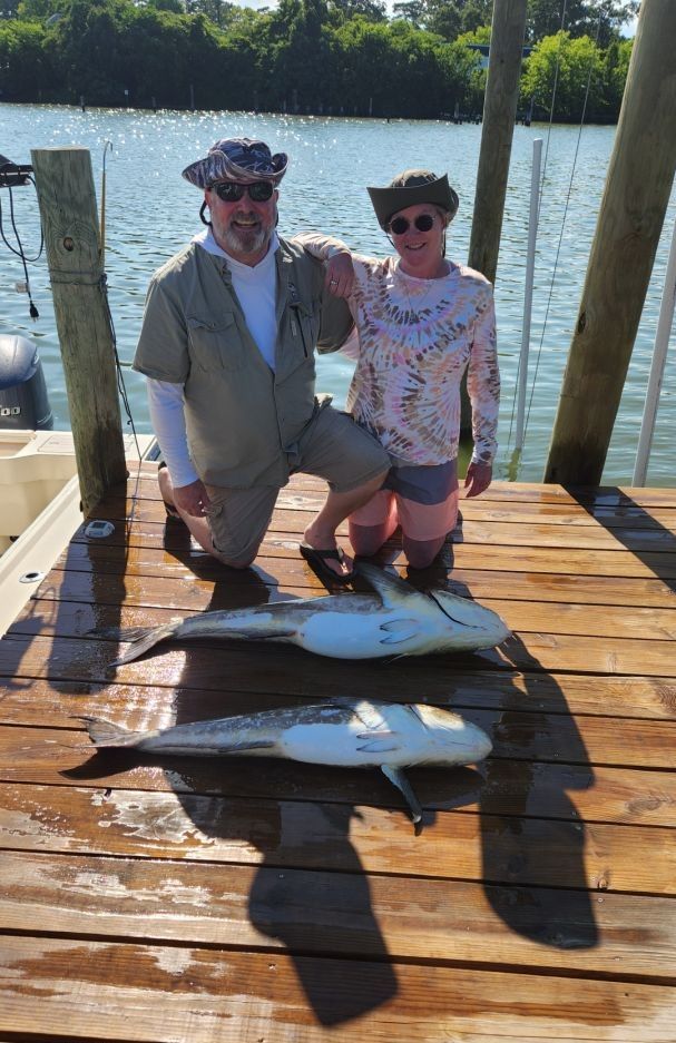 Two anglers with a catch of two big fish during a fishing trip