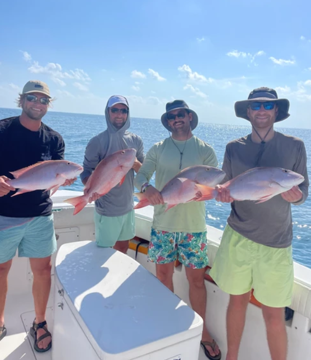 Three anglers landing a catch in Key West