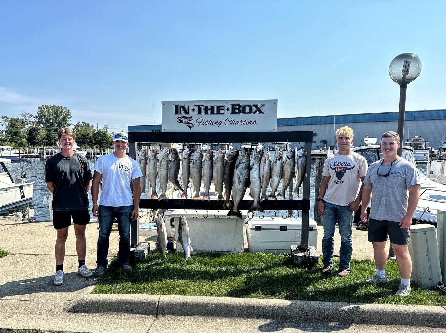 A group of 4 anglers with a single big fish caught in MI