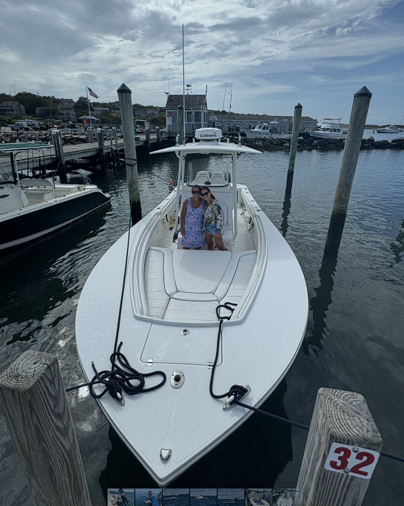 White fishing boat docked at marina in New Bedford MA with center console design