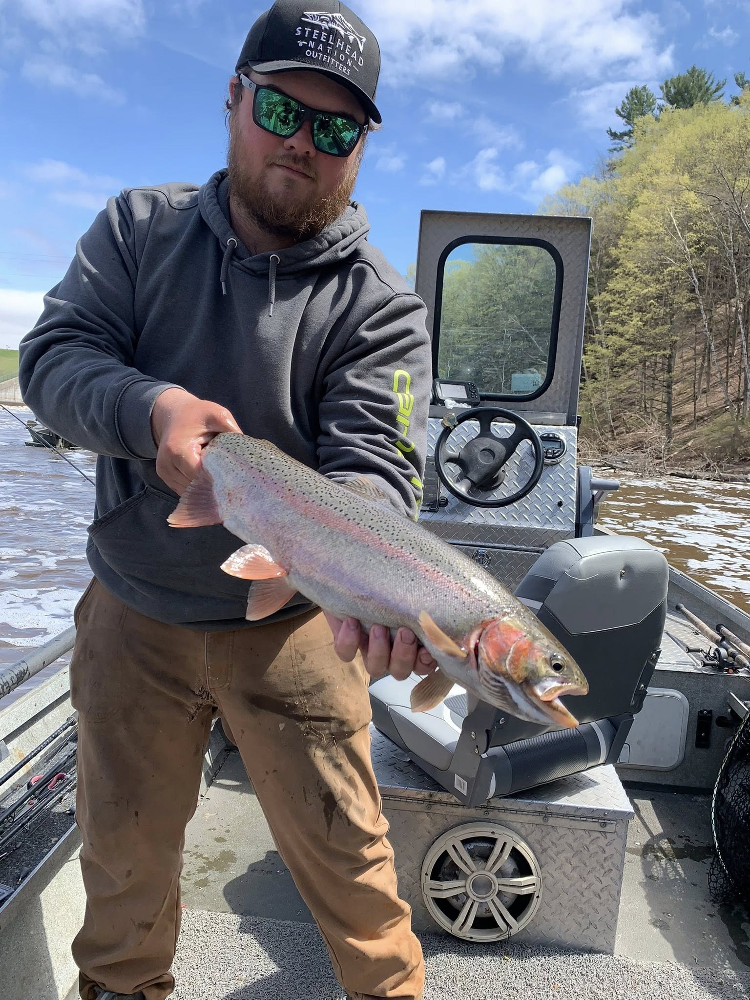 Rainbow trout caught while fishing in Brethren MI displayed on boat deck