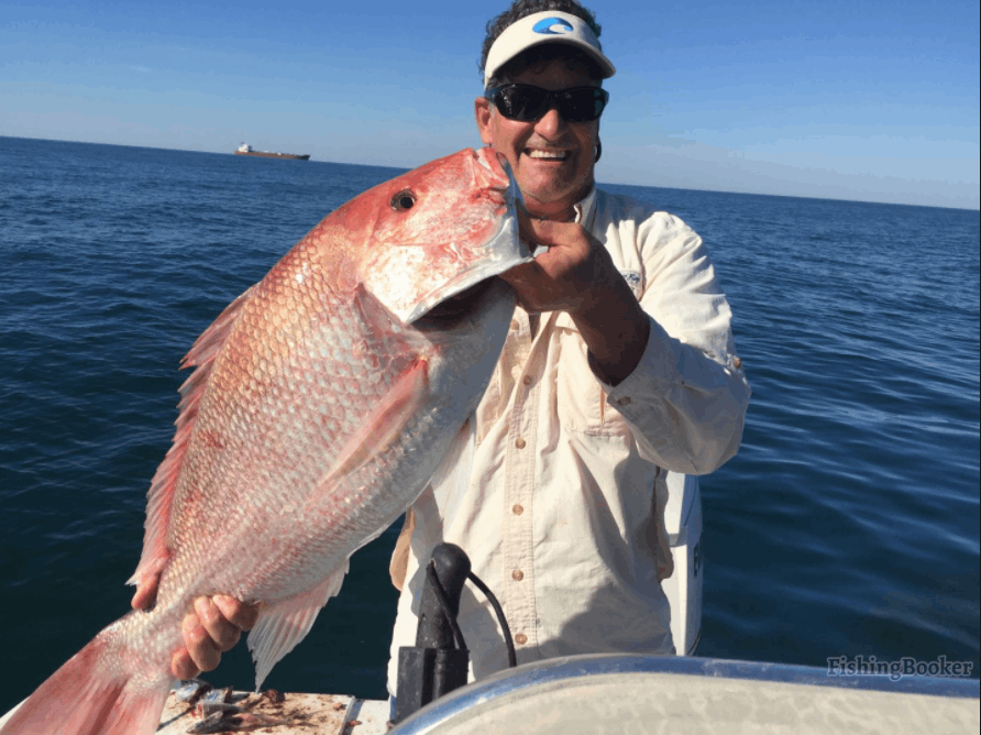 Angler holding a 24-inch fish in MS