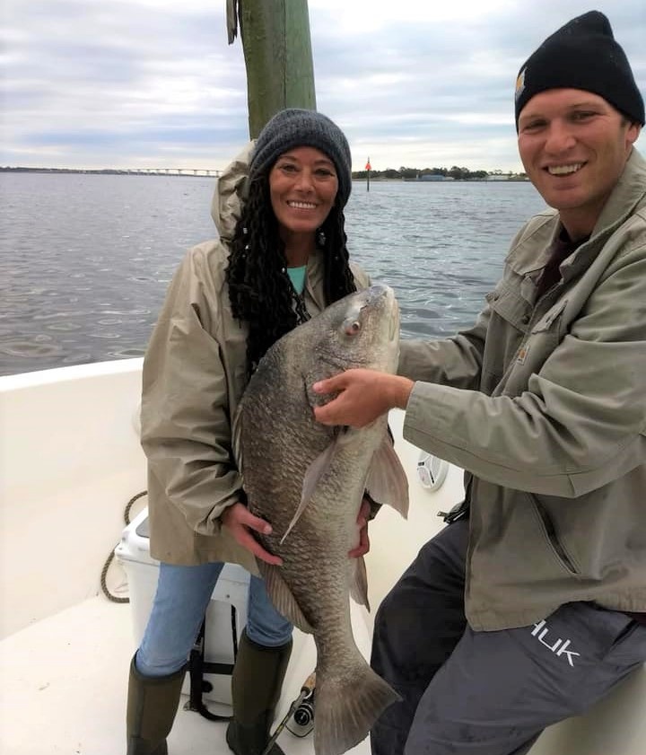 Angler with a huge black drum fish in MS