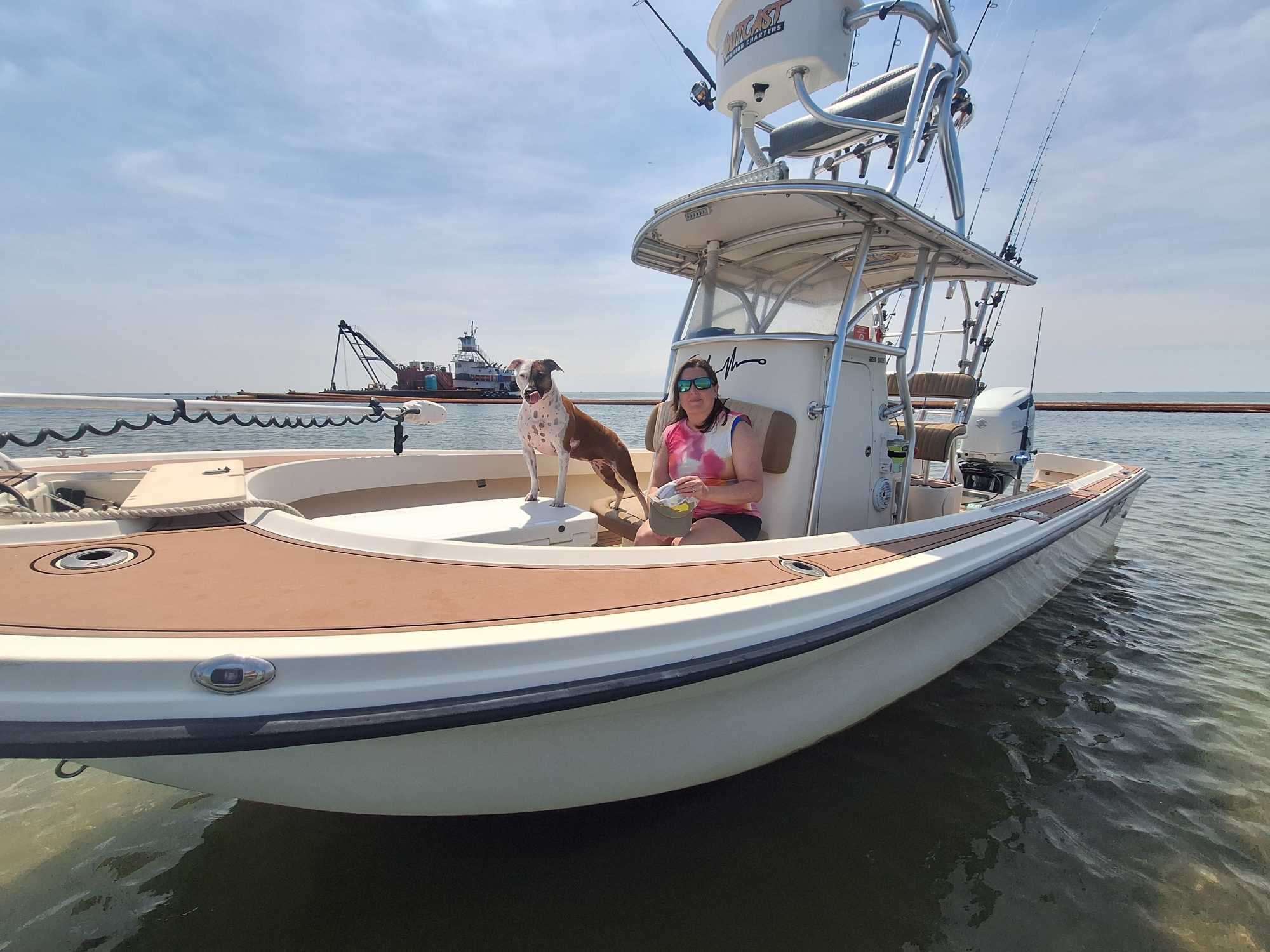 Fishing boat with dog on deck in calm waters near Wanchese NC harbor