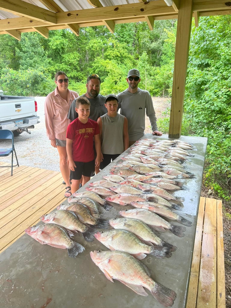 A group of 3 big fish being caught by 5 people in Grenada