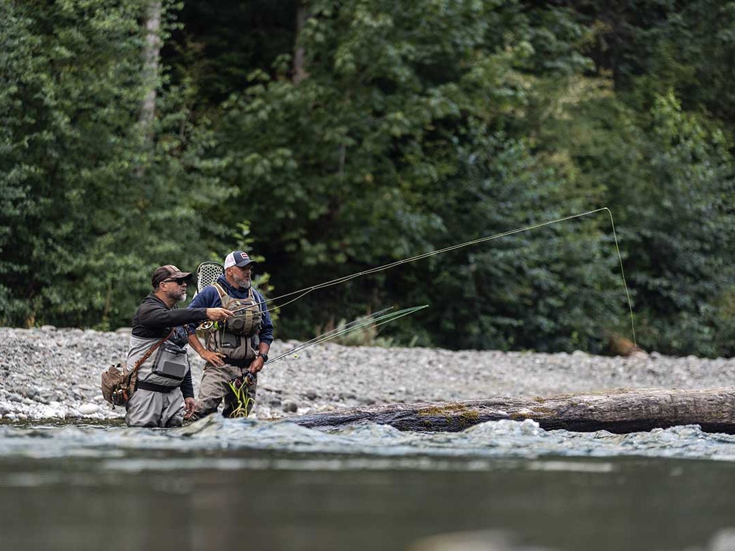 Private fly fishing instruction lesson on Pacific Northwest river with casting practice