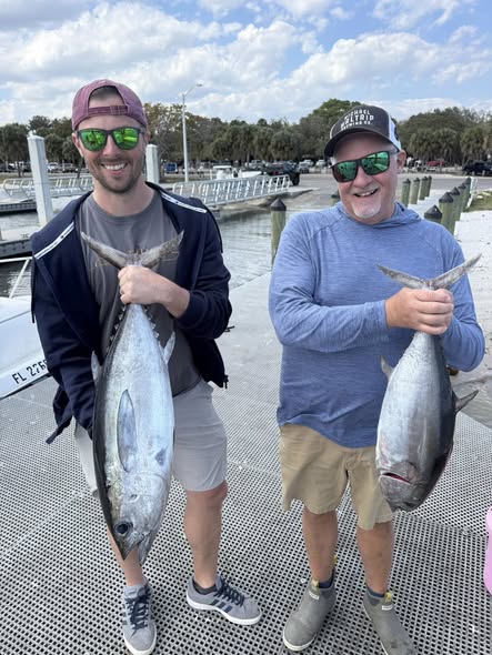 Two anglers displaying freshly caught Blackfin Tuna and Bluefin Tuna at Jensen Beach FL marina dock