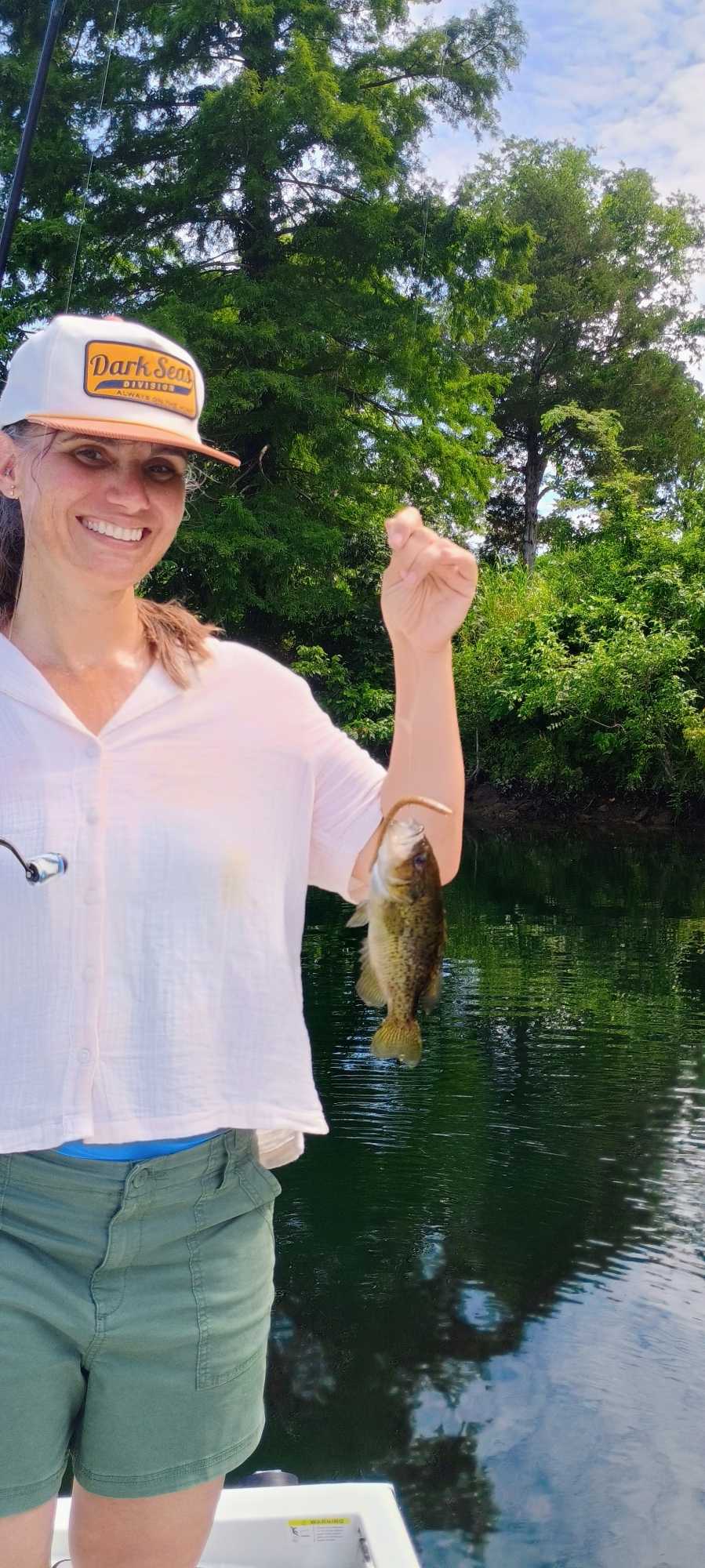 Angler holding freshly caught bass while fishing in Branson Missouri