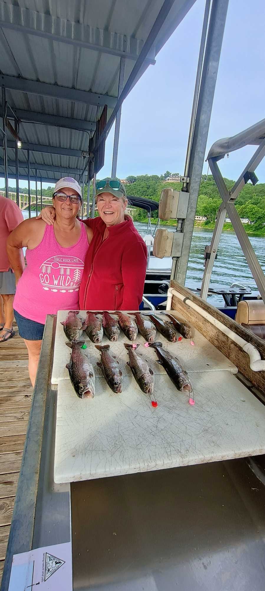 Fishing trip results displayed on cleaning table at dock in Branson MO with multiple caught fish