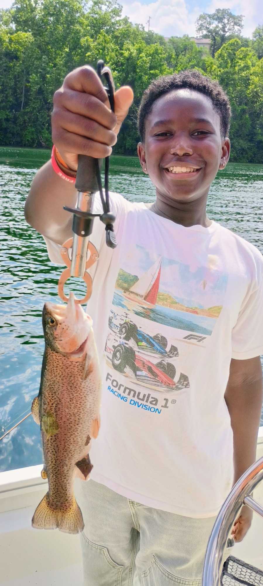 Rainbow trout caught fishing in Branson MO held up on fishing stringer