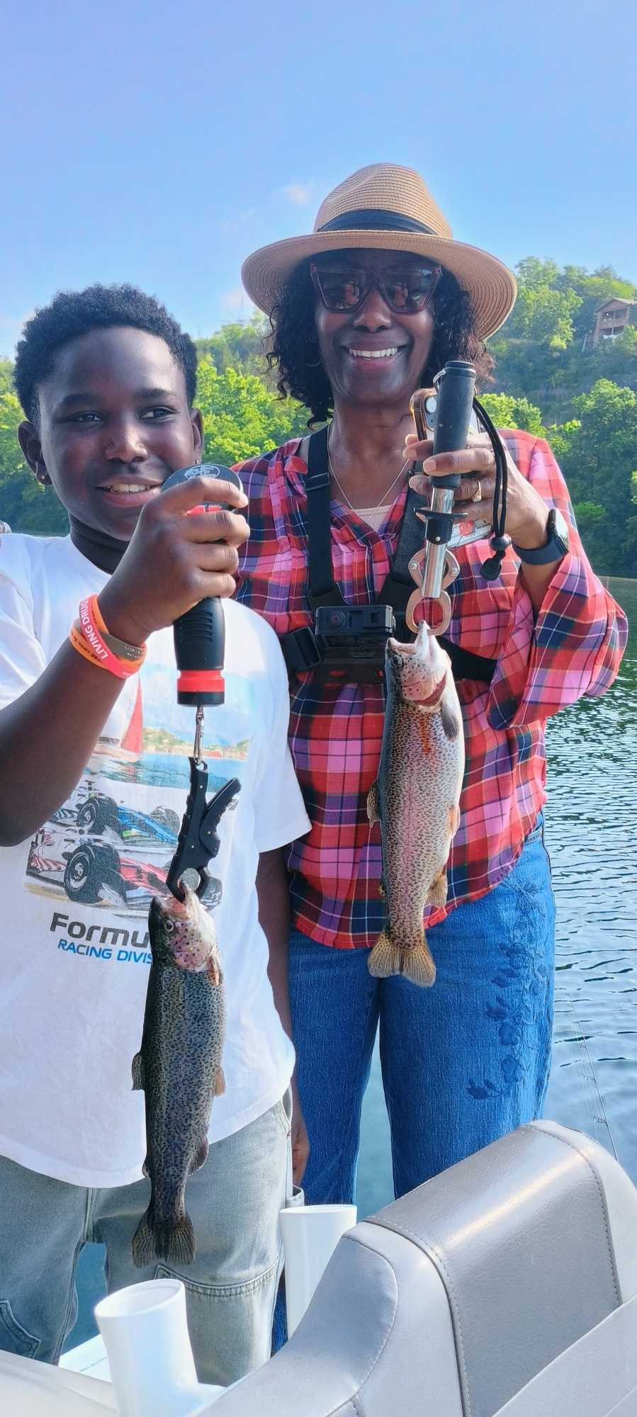 Two rainbow trout caught while fishing in Branson MO displayed on boat