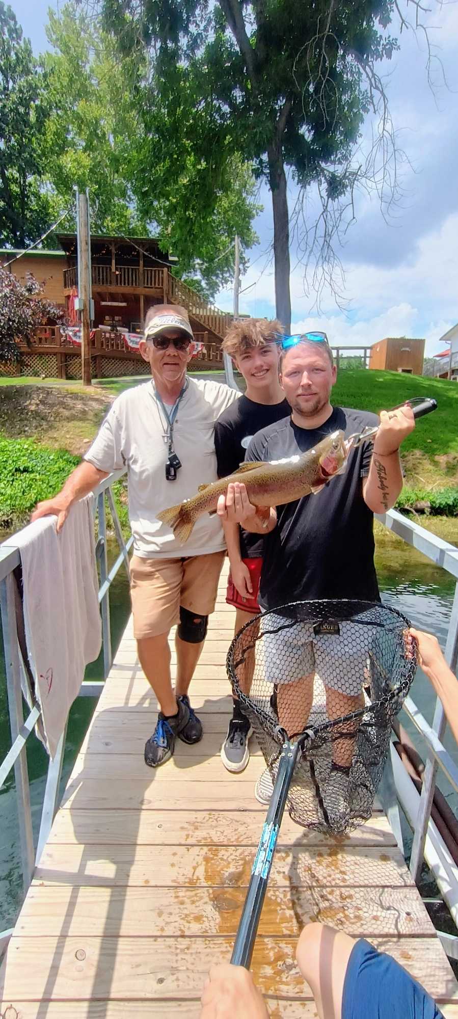Rainbow trout catch displayed on fishing dock in Branson MO with fishing net
