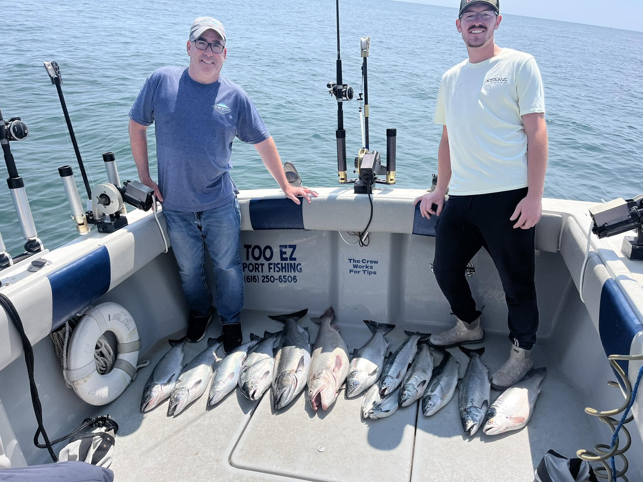 Successful fishing charter displaying multiple Chinook salmon catch on boat deck in Muskegon MI