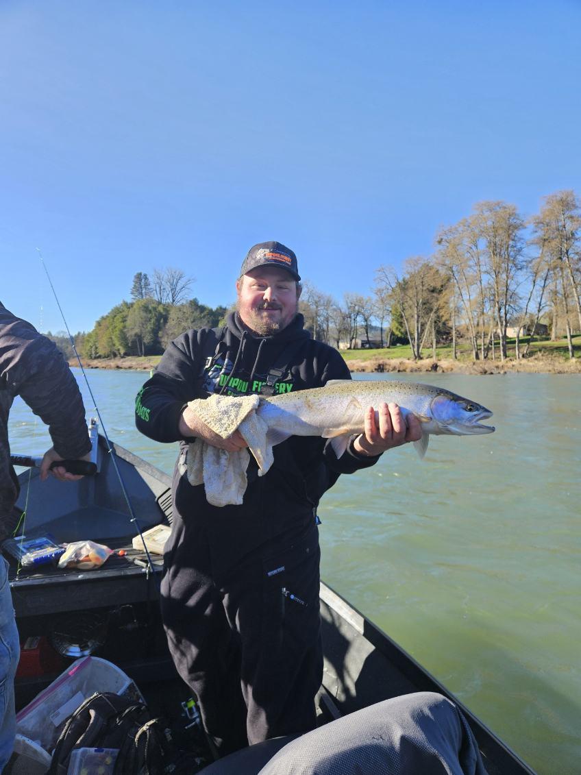 Angler holding freshly caught salmon on fishing boat in Roseburg OR
