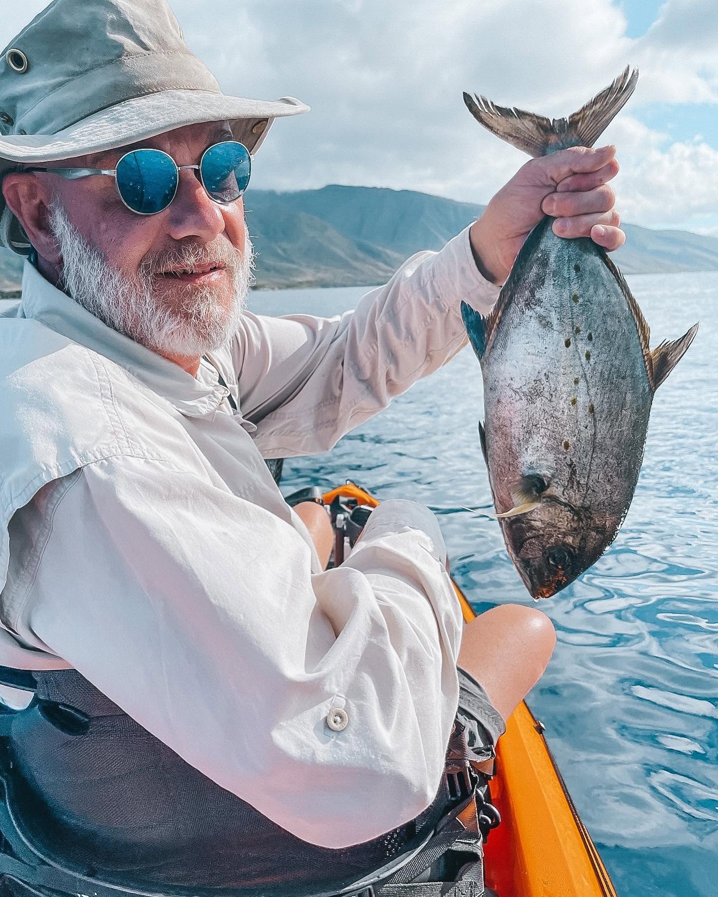 Freshly caught fish being held up after successful fishing trip in Lahaina Hawaii
