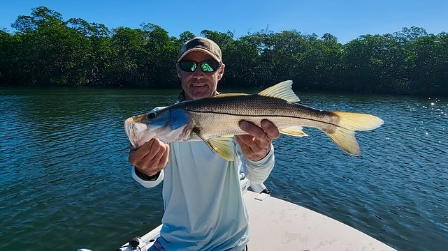 Family fishing charter boat in Islamorada shallow waters with kids learning light tackle fishing