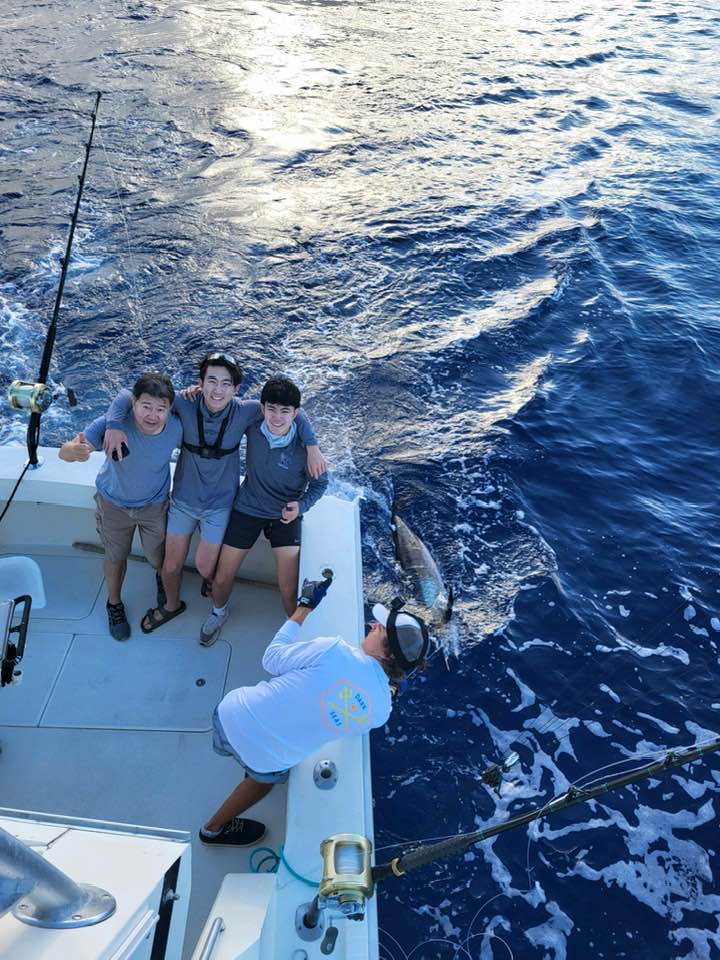 Deep sea fishing boat in Kailua-Kona Hawaii waters with fishing equipment and crew