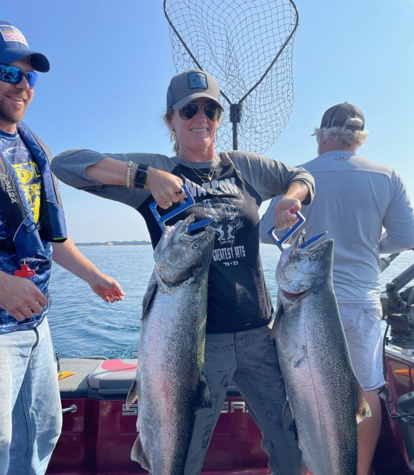 Two anglers fishing for rainbow trout and lake trout in MI
