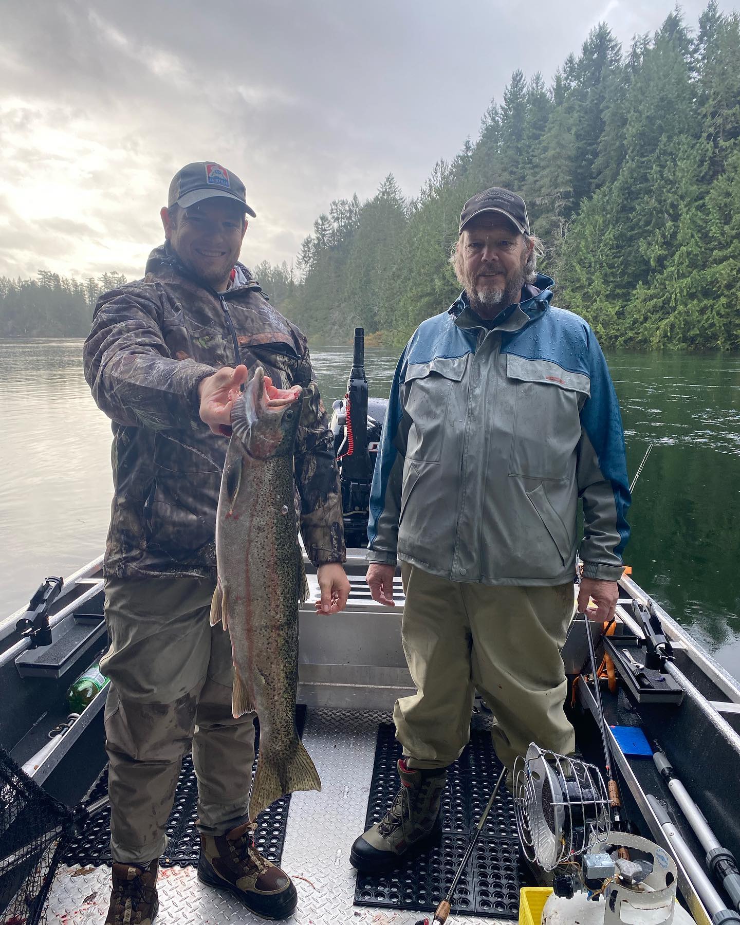 Angler landing a large rainbow trout in BC