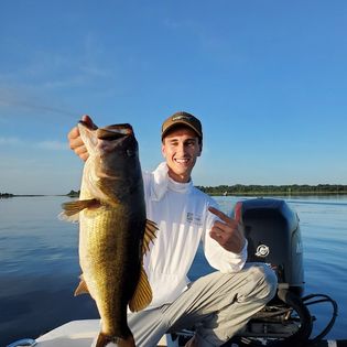 A fisherman holding a 27-inch catch in Kissimmee