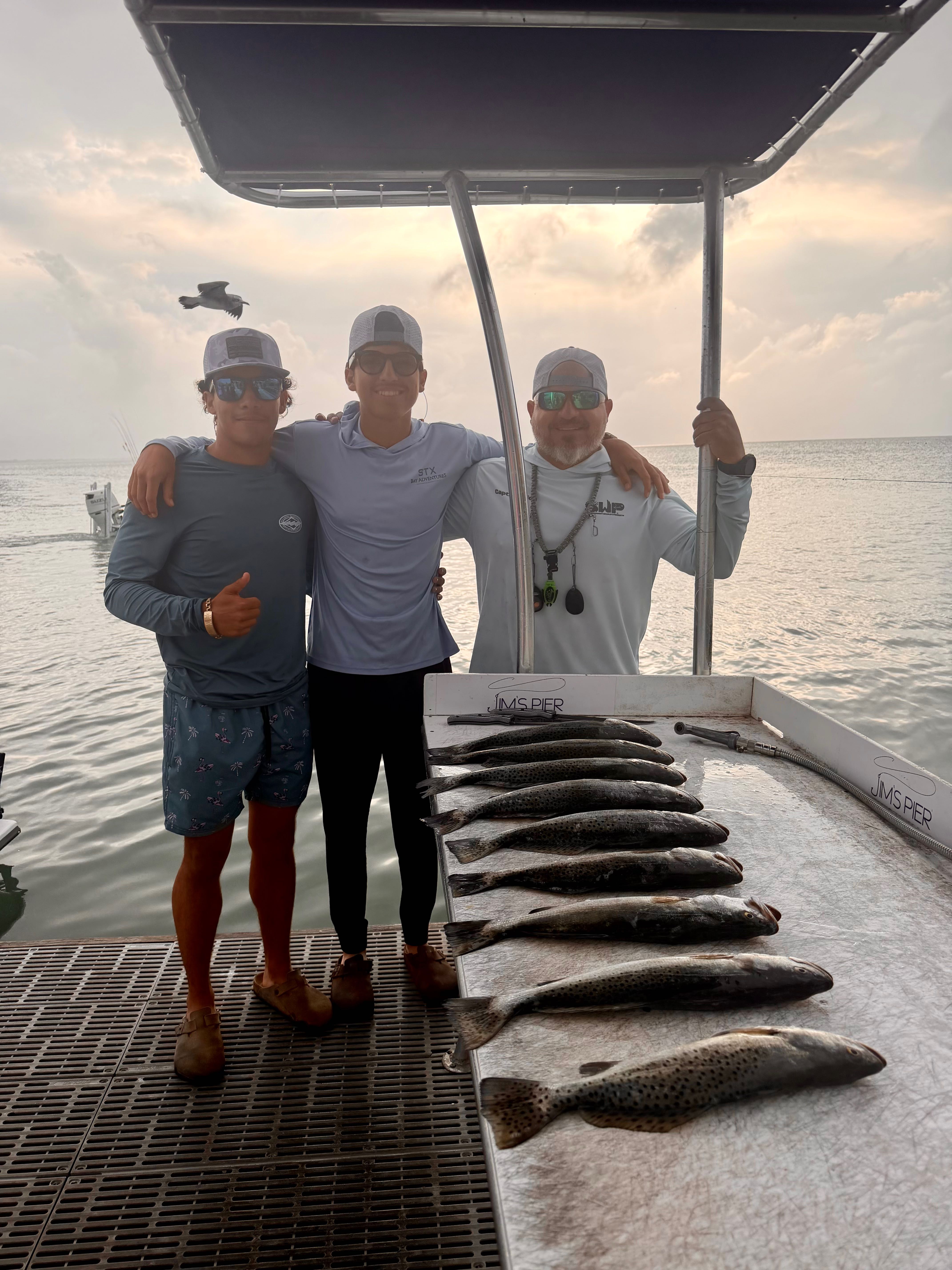 Fishing charter catch of speckled trout laid out on boat deck in Brownsville TX