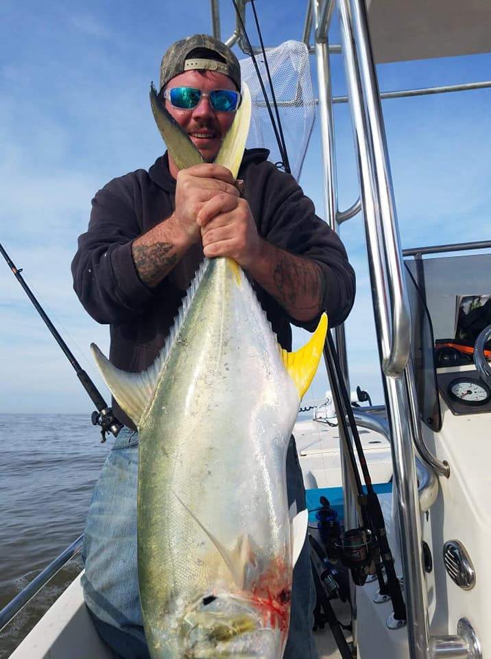 A lone angler reels in their catch in FL