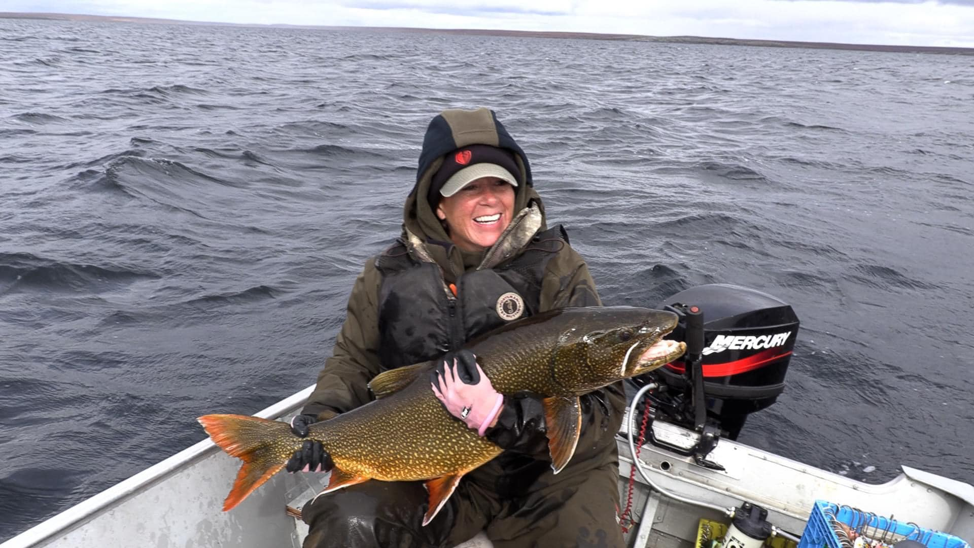 A fisherman holding a 29-inch fish in Yellowknife
